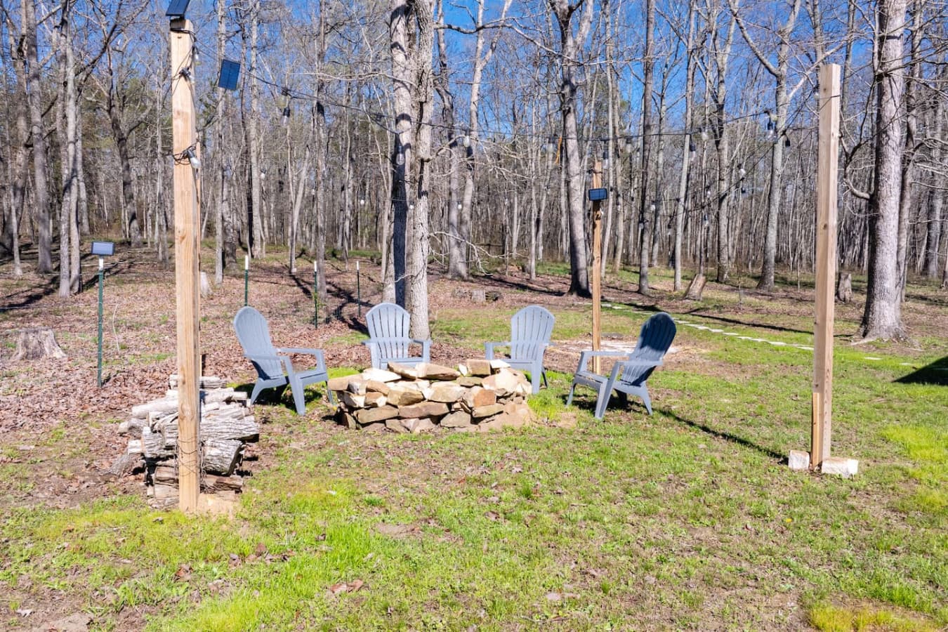Gather around the stone fire pit, surrounded by cozy Adirondack chairs and twinkling string lights, the perfect spot for roasting marshmallows and sharing stories beneath the trees and stars.