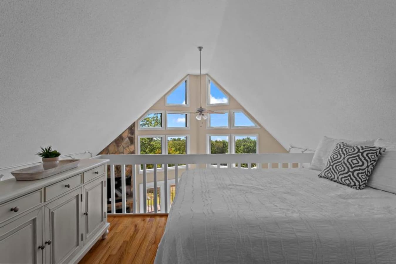 Unique loft bedroom with a queen bed and ladder access, offering a fun and cozy retreat for extra guests.