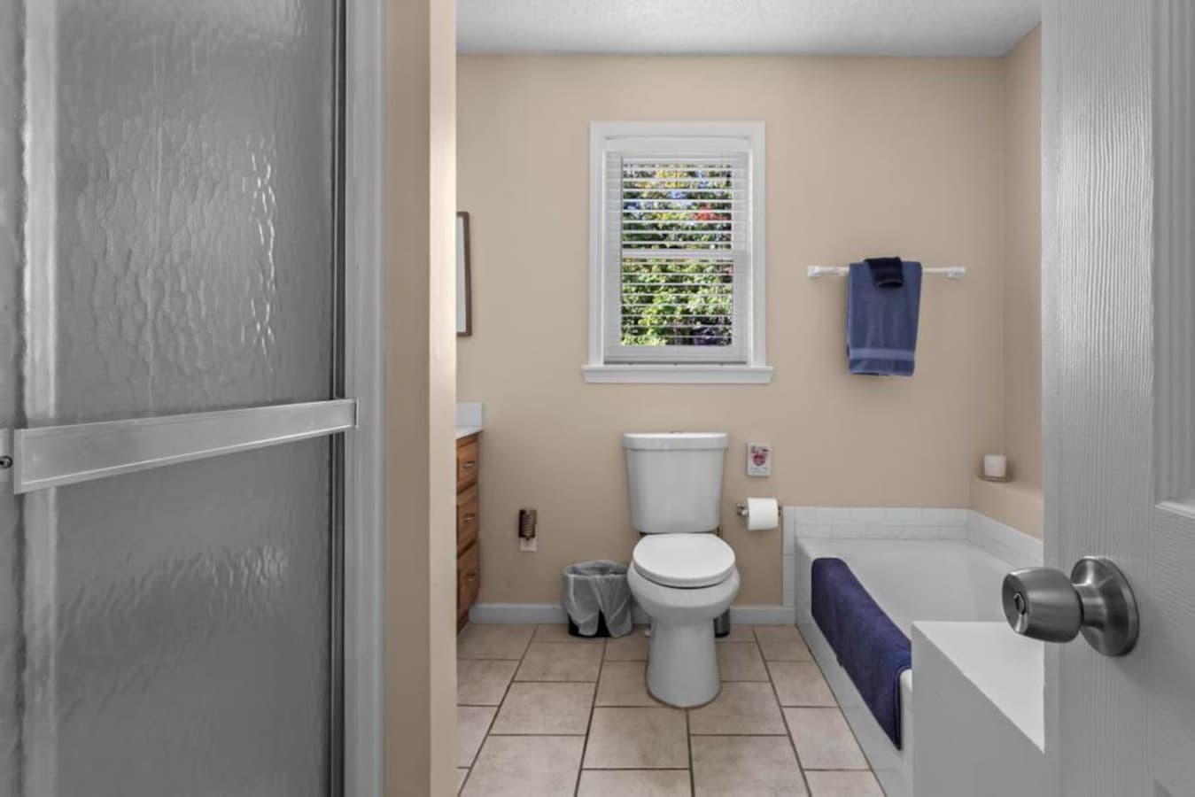 Relax in the full bathroom with a bathtub and separate shower, perfect for unwinding after a day of exploring.