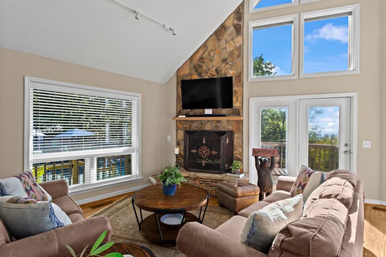 Sunlight pours through huge windows into this open-concept living space, where cozy seating and a 50” HDTV invite you to unwind in comfort.