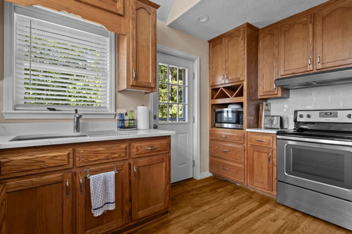 Fully equipped kitchen with all the essentials for preparing meals, including a fridge, stove, microwave, and BBQ utensils.