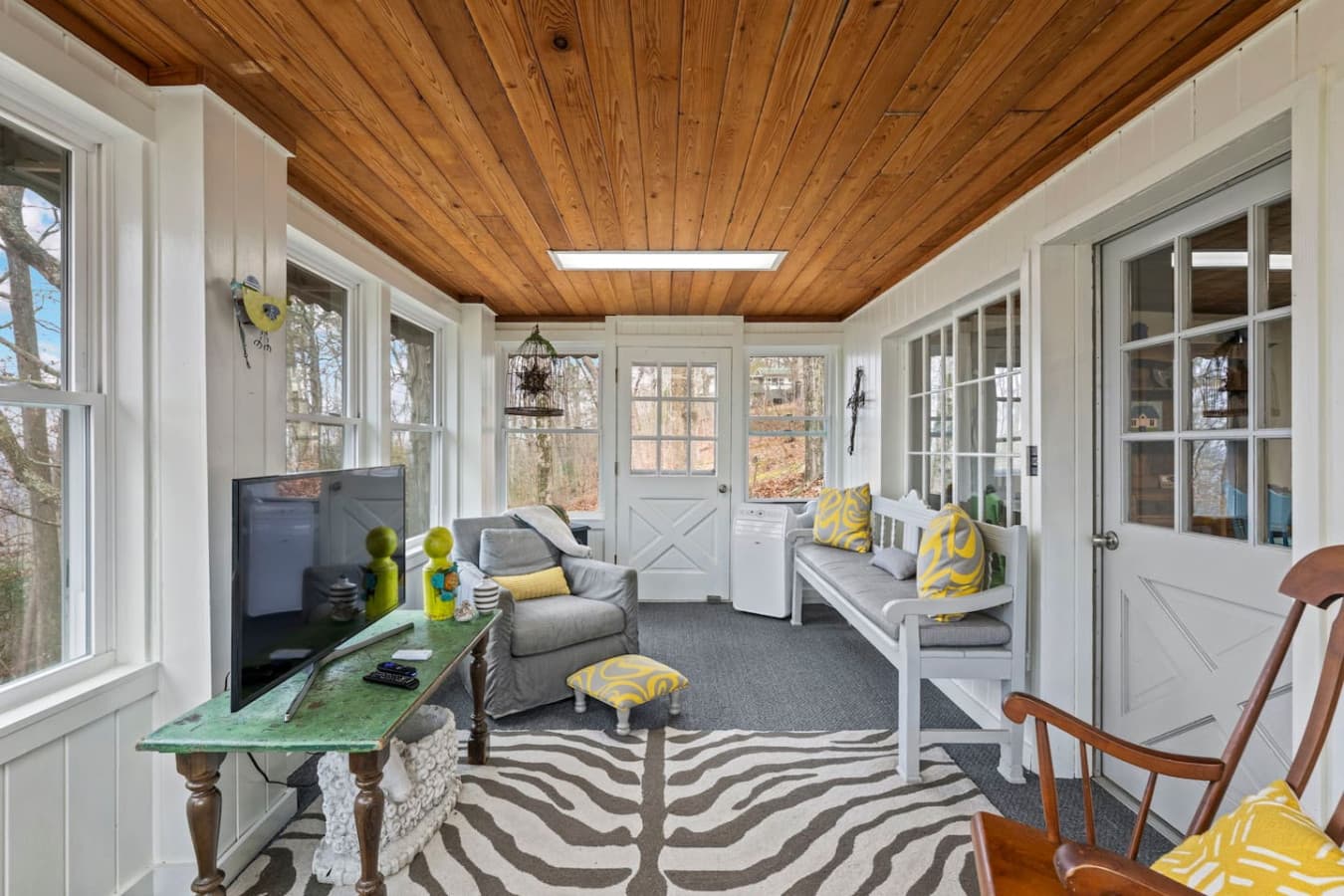 Relax on the lower porch with cozy seating and natural light all around.