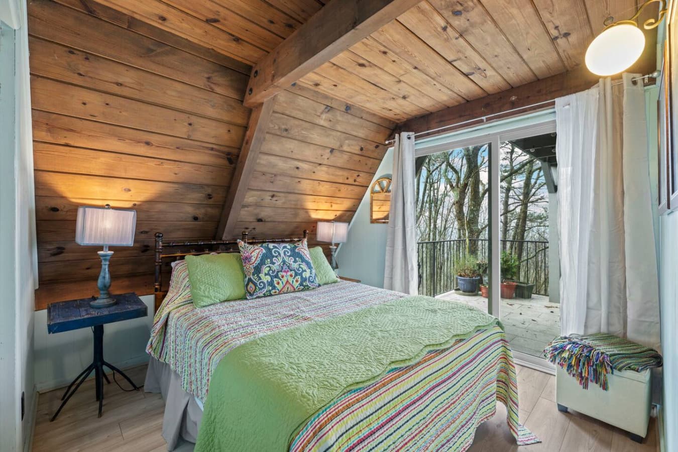 Inviting queen bedroom with beautiful natural light and balcony access.