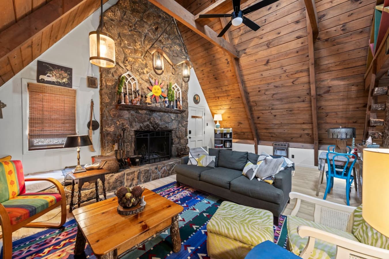 Cozy main-level living room with plush seating, a smart TV, and a warm indoor fireplace.