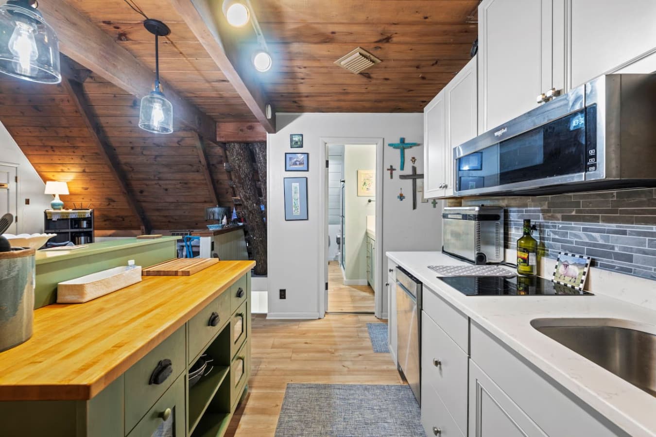 Compact two-burner setup with microwave, toaster oven, and dishwasher.