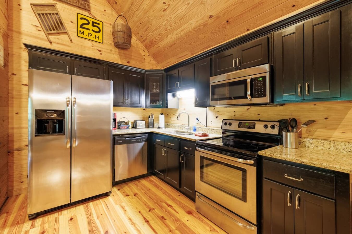 Well-stocked kitchen with fridge, stove, oven, microwave, and dishwasher.