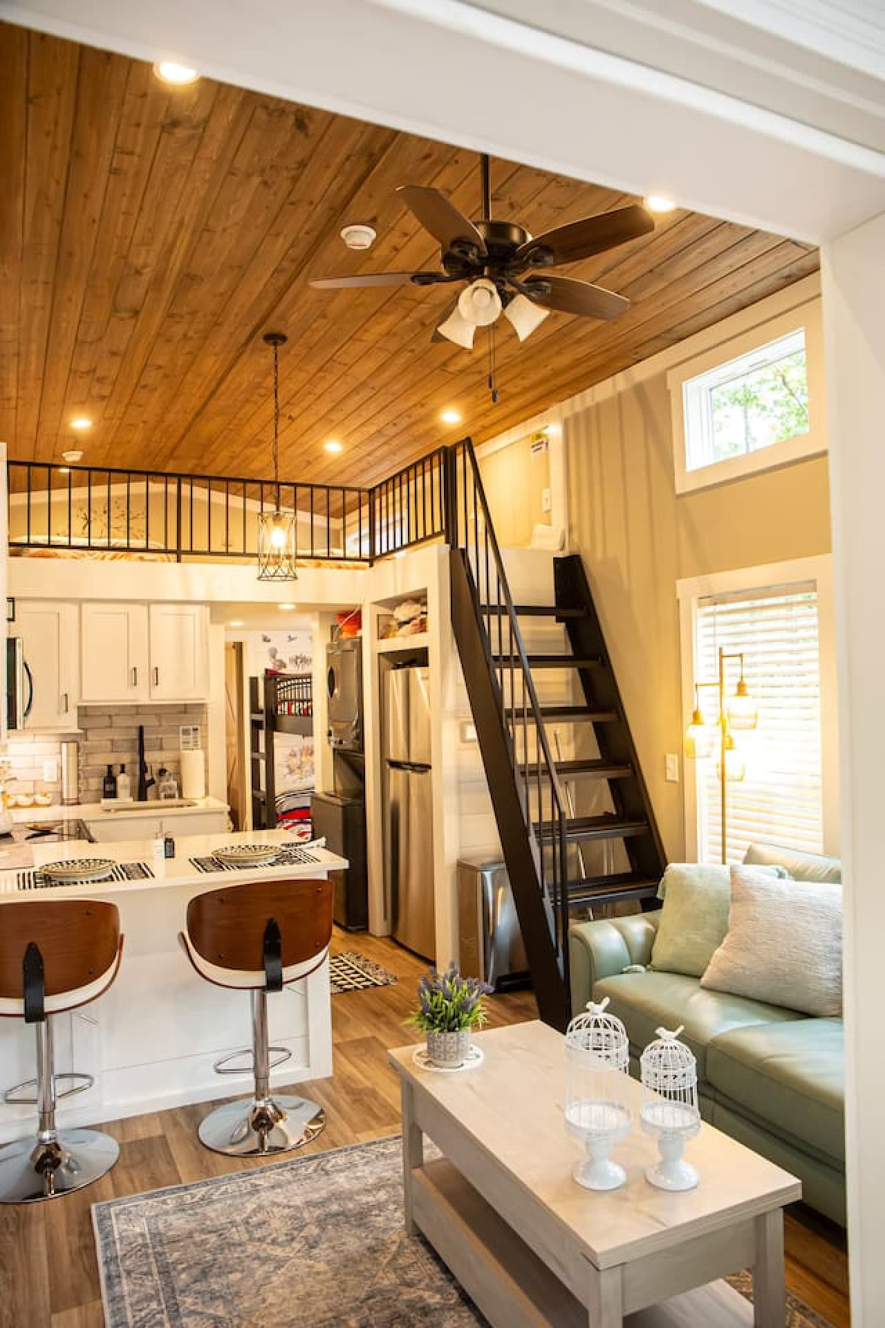 Living room with bar top and loft access.