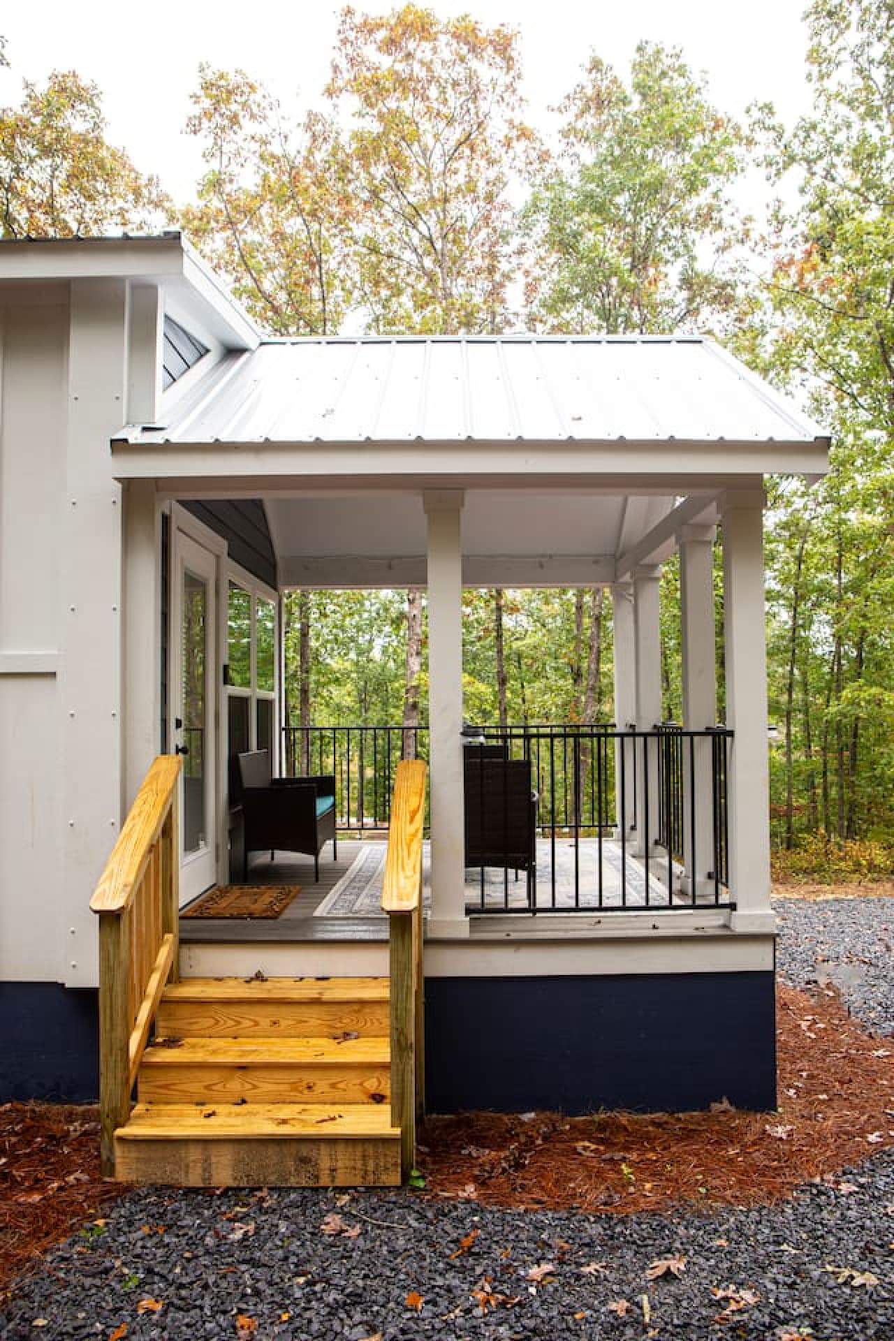 Covered front porch with side stair access.