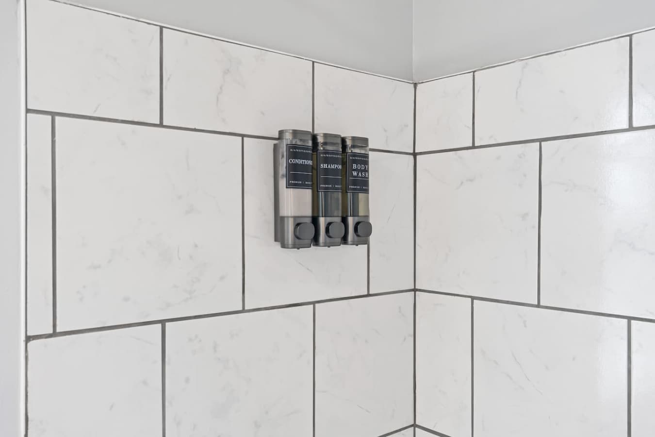 Full bathroom featuring shampoo, conditioner, body soap, and fresh towels.
