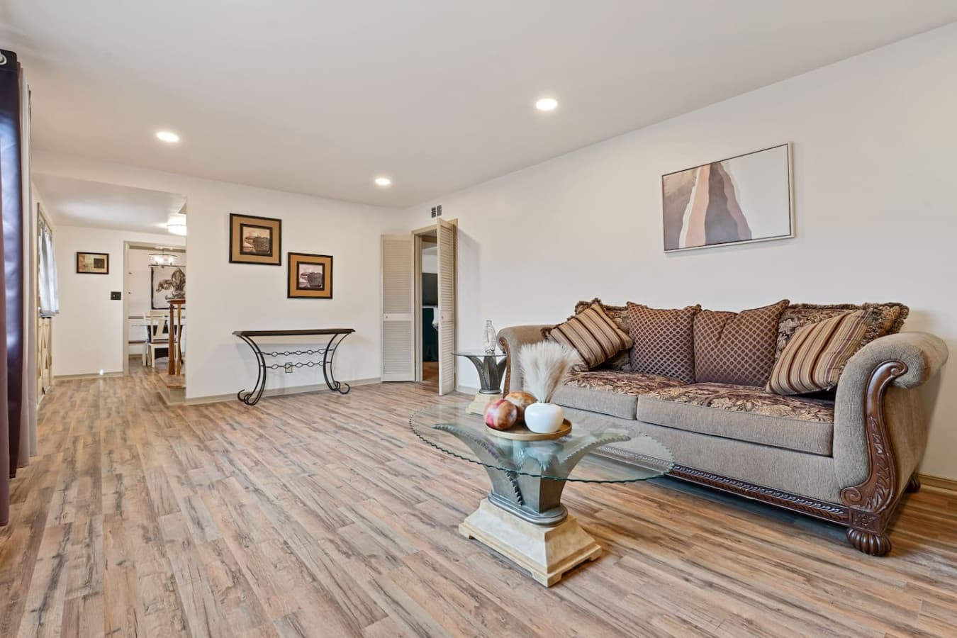 Living room with air conditioning, heating, and ceiling fan for year-round comfort.