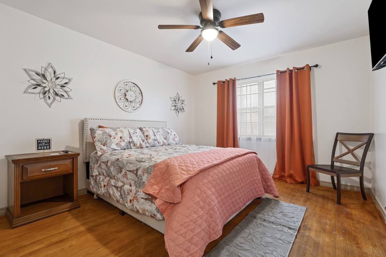 Cozy third bedroom upstairs with queen bed, smart TV, and serene atmosphere.
