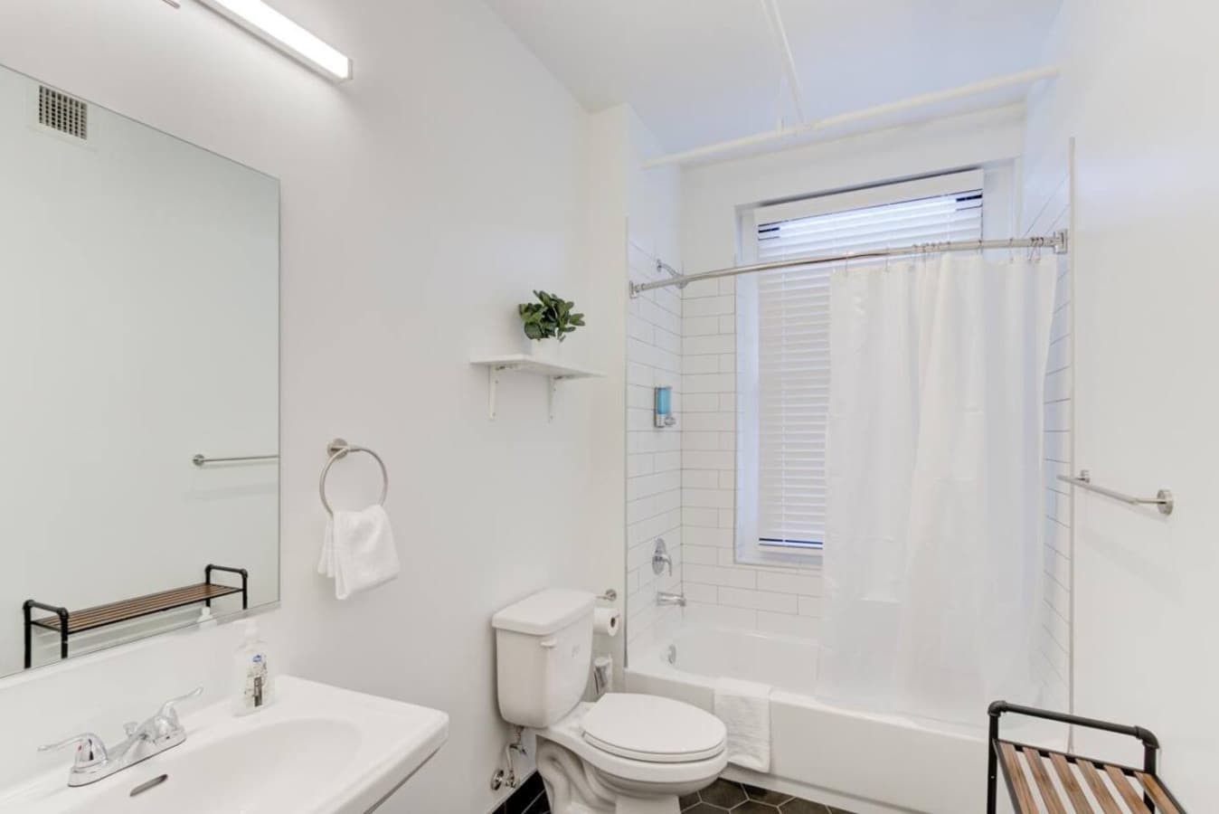 Full-size bathroom with tub, stocked with soap, shampoo, and fresh white towels for your stay.