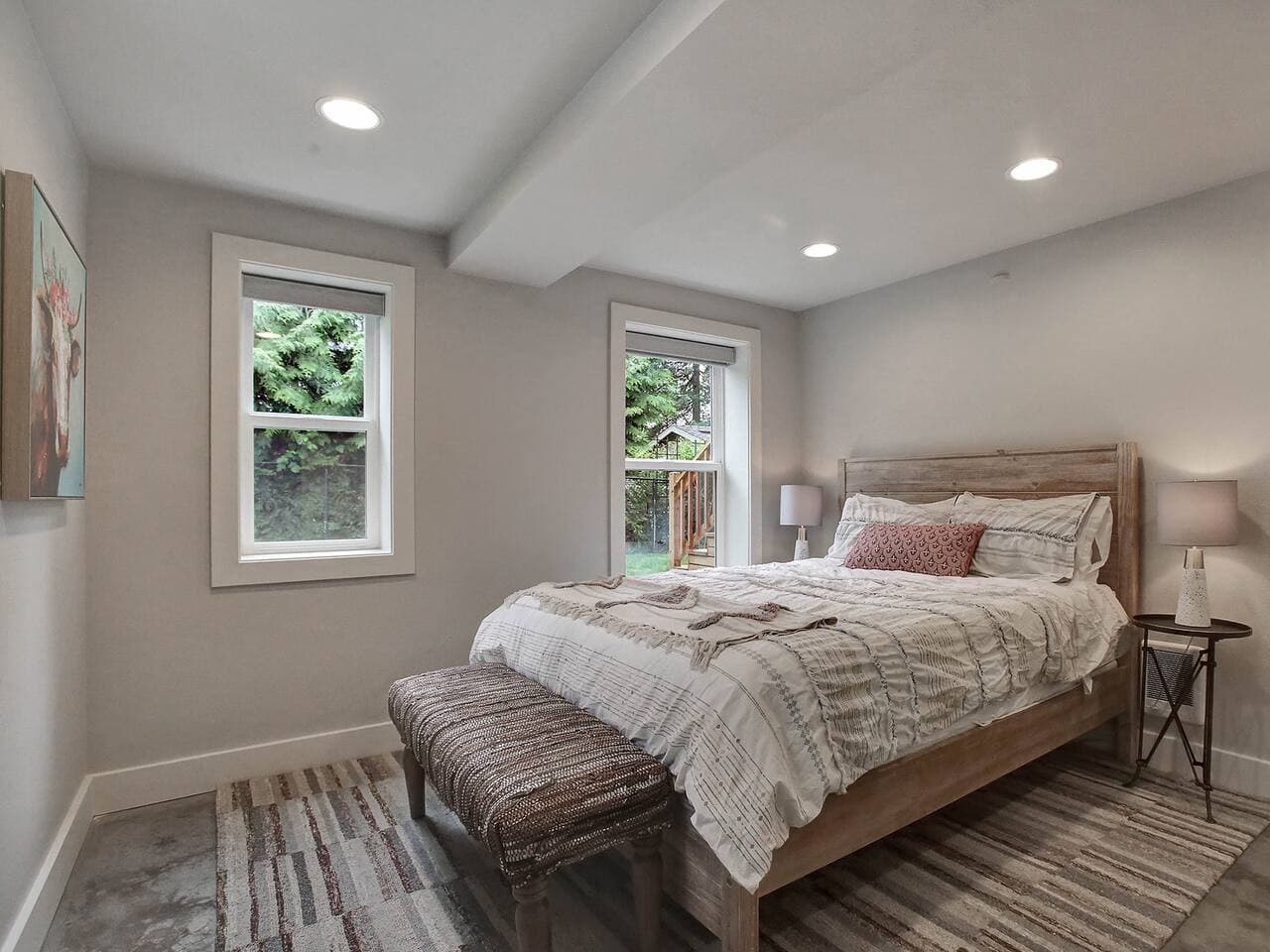 Bright queen bedroom with peaceful garden views.