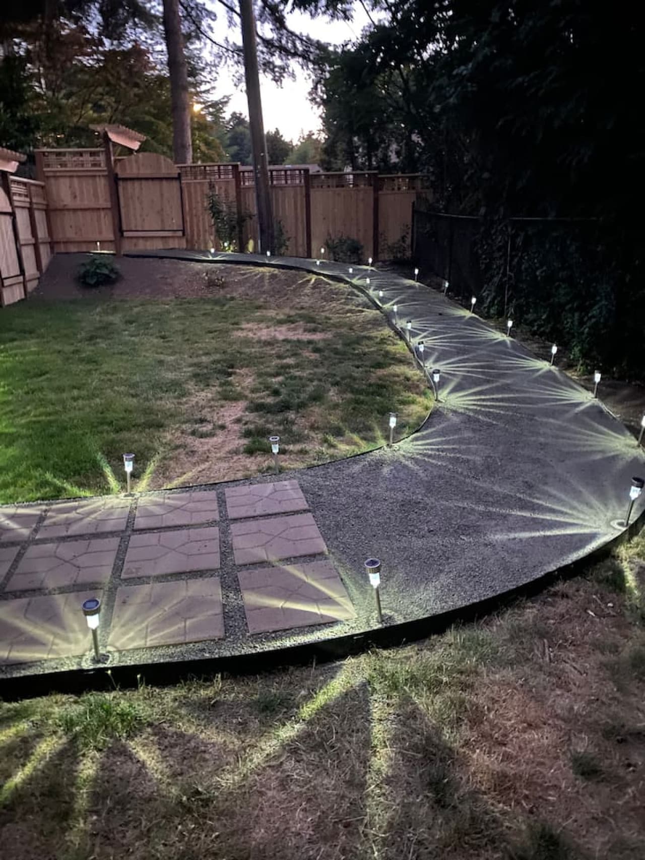 Well lit solar light pathway leading to entrance.