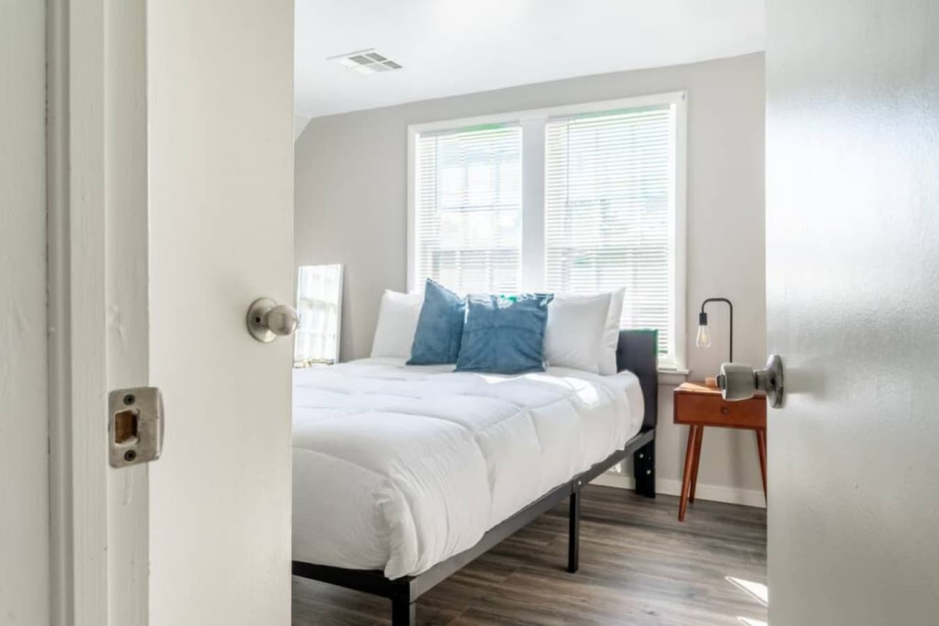 A bright queen bedroom with fresh linens and a calm atmosphere for easy rest.