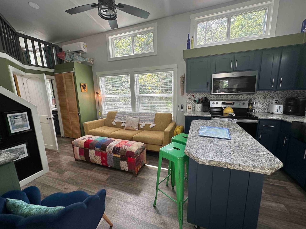 The living room and kitchen offer an open-concept layout with a Smart TV, modern appliances, and a bright, welcoming space to relax and gather.