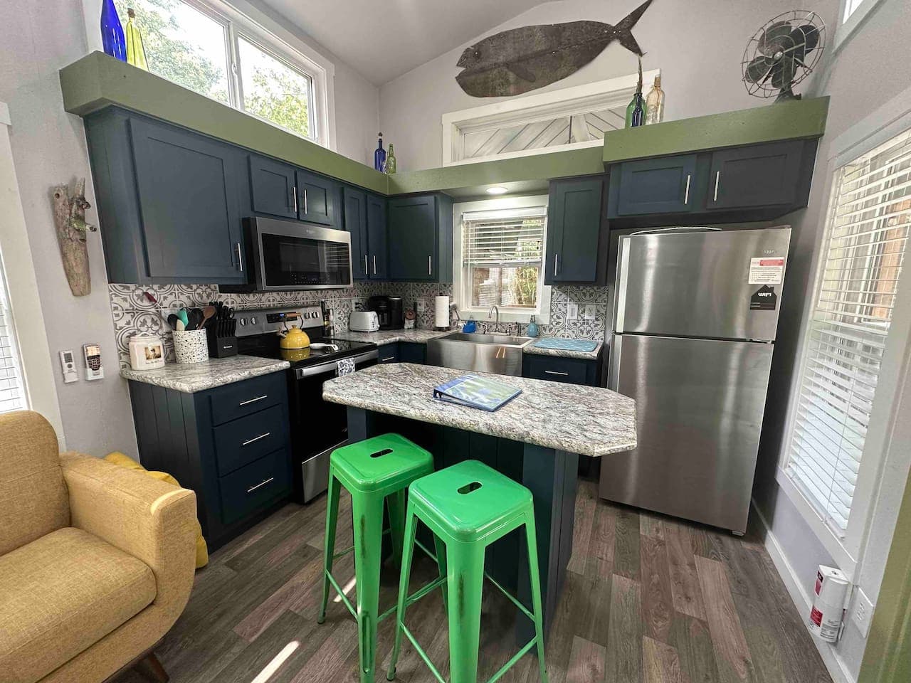 The dining area features a cozy counter with two bar stools—perfect for meals, morning coffee, or casual conversation.