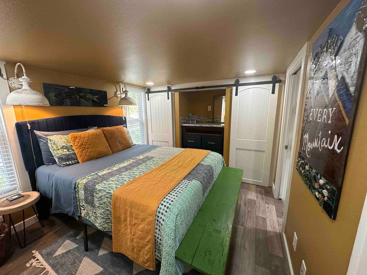 The master bedroom on the main floor includes an attached full bathroom with a private access door.