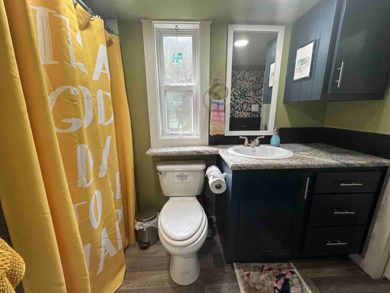 The full bathroom includes a toilet, with two rolls of toilet paper provided for your stay.