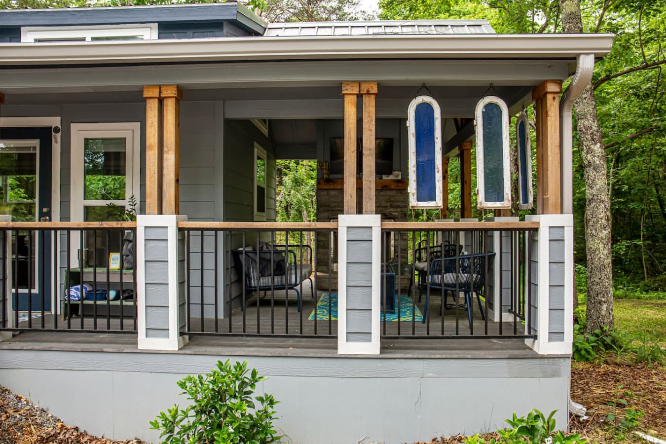 The wrap-around porch offers a relaxing space to enjoy the fresh air and scenic views of the surrounding nature.
