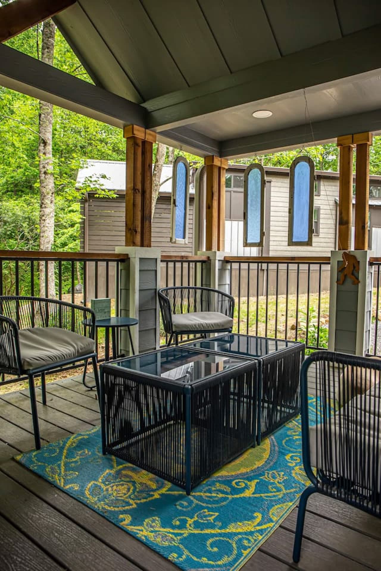 Outdoor seating surrounds the fireplace, creating a warm and inviting spot to relax and enjoy the fresh mountain air.
