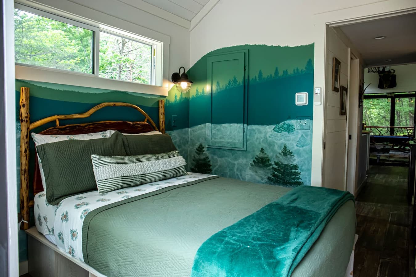 The master bedroom features a queen bed on the main floor with a lockable door, linens provided, and a dresser and closet with hangers for storage.