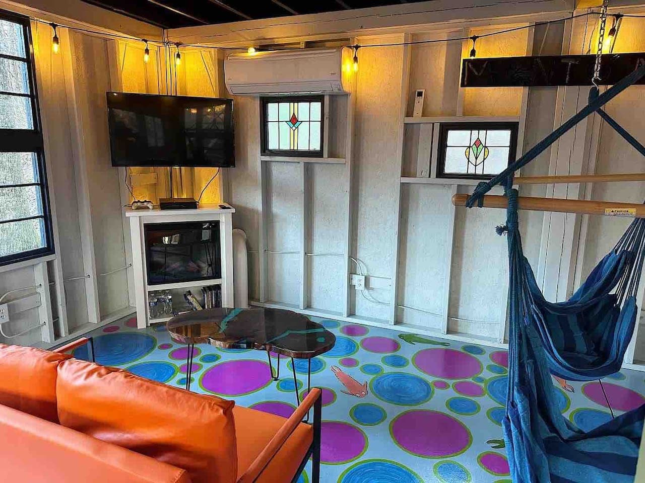 The common area, Creek House Lounge, features foosball, Pac-Man, a TV with DVD and PlayStation, crafts, and cozy hanging chairs for guests to enjoy.
