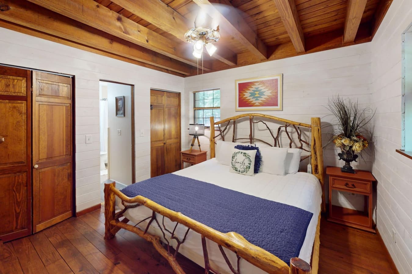 Rock Haven – Bright and inviting king-sized bedroom with cozy bedding and handcrafted details.