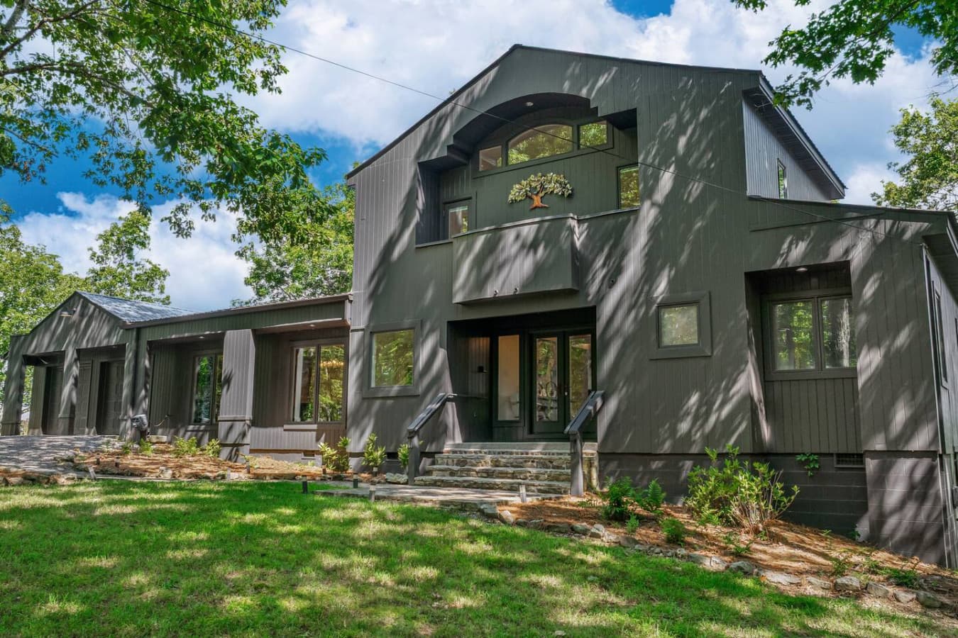 Perched on the edge of majestic Lookout Mountain, this striking black house offers an unforgettable escape with sweeping views of the valley below and breathtaking sunsets every evening.