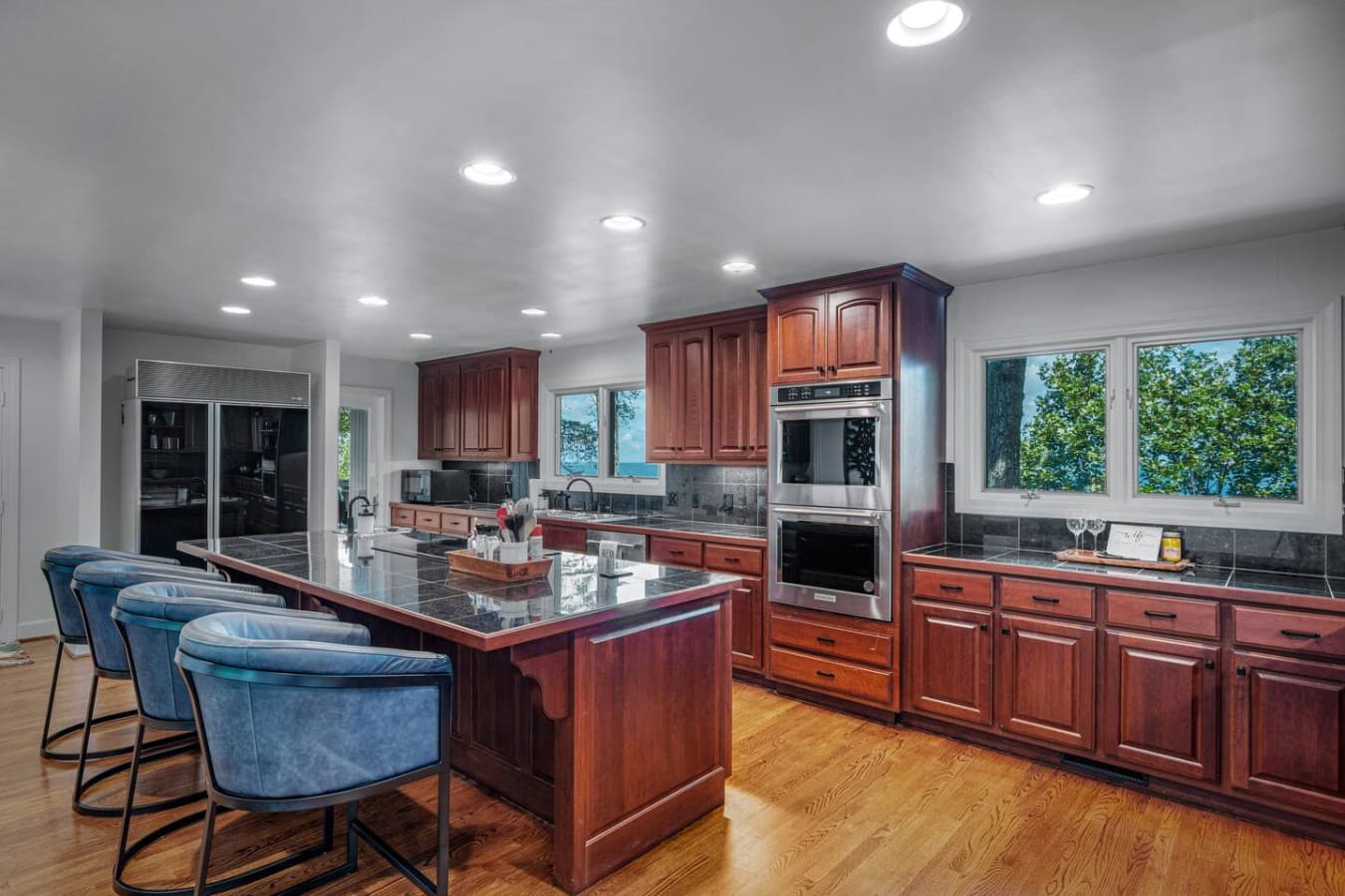Cook with a view in this chef’s dream kitchen featuring double ovens, island cooktop, and mountain light.