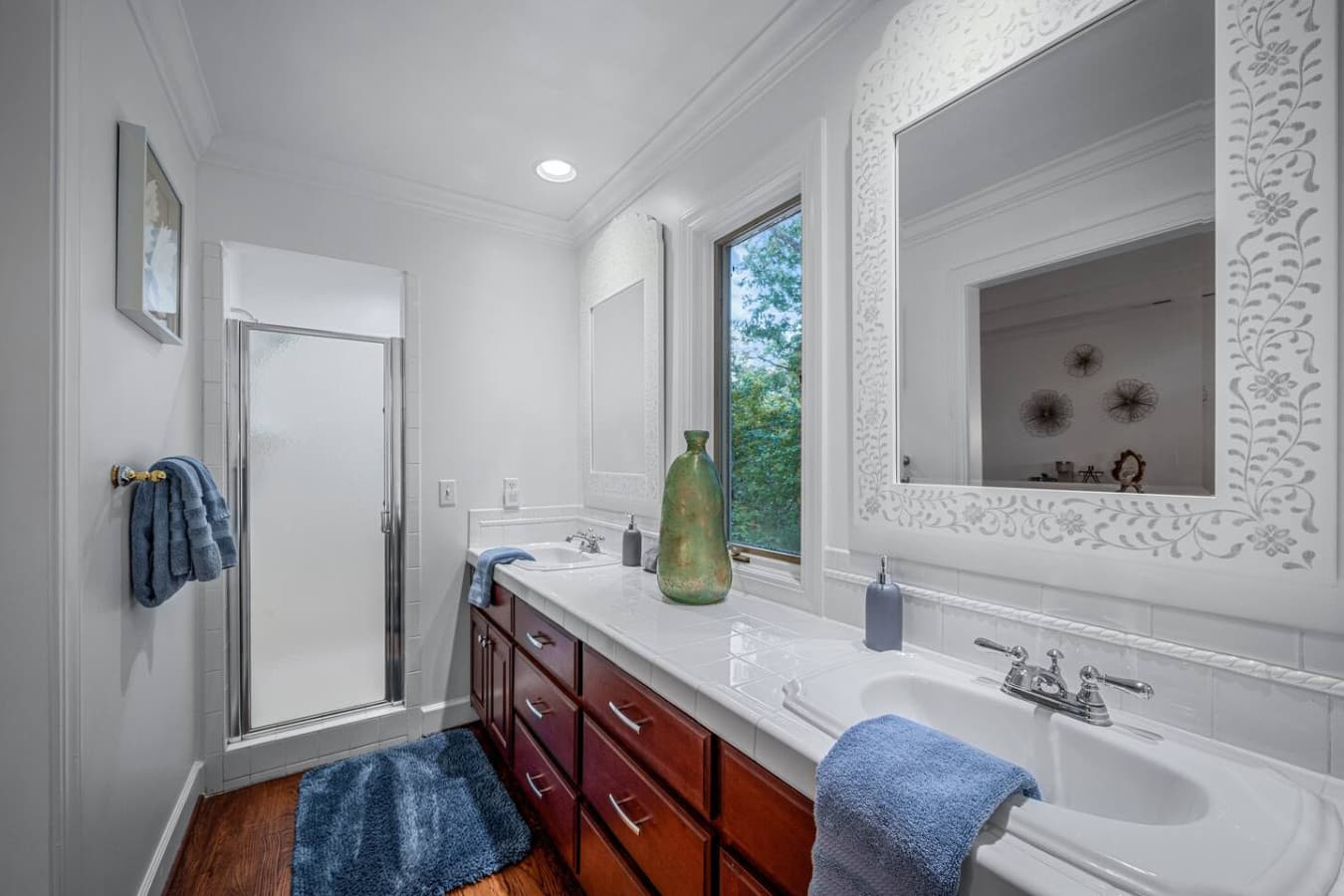 This private ensuite offers a shower, double vanity, and toilet closet, complete with toiletries, hair dryer, and fresh towels.