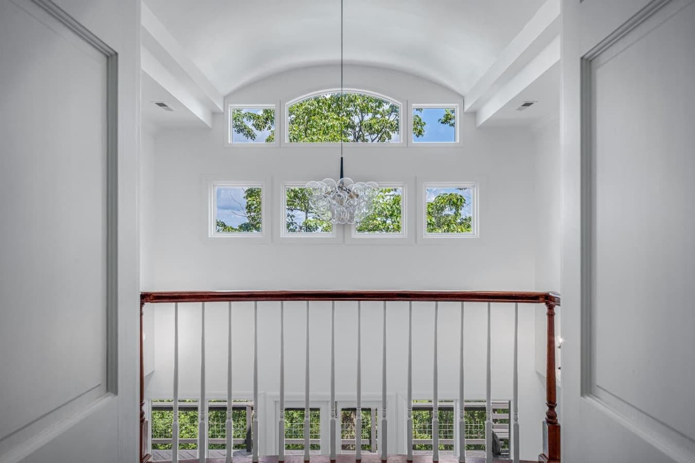 Open hallway area featuring an arched window and relaxing nature views.