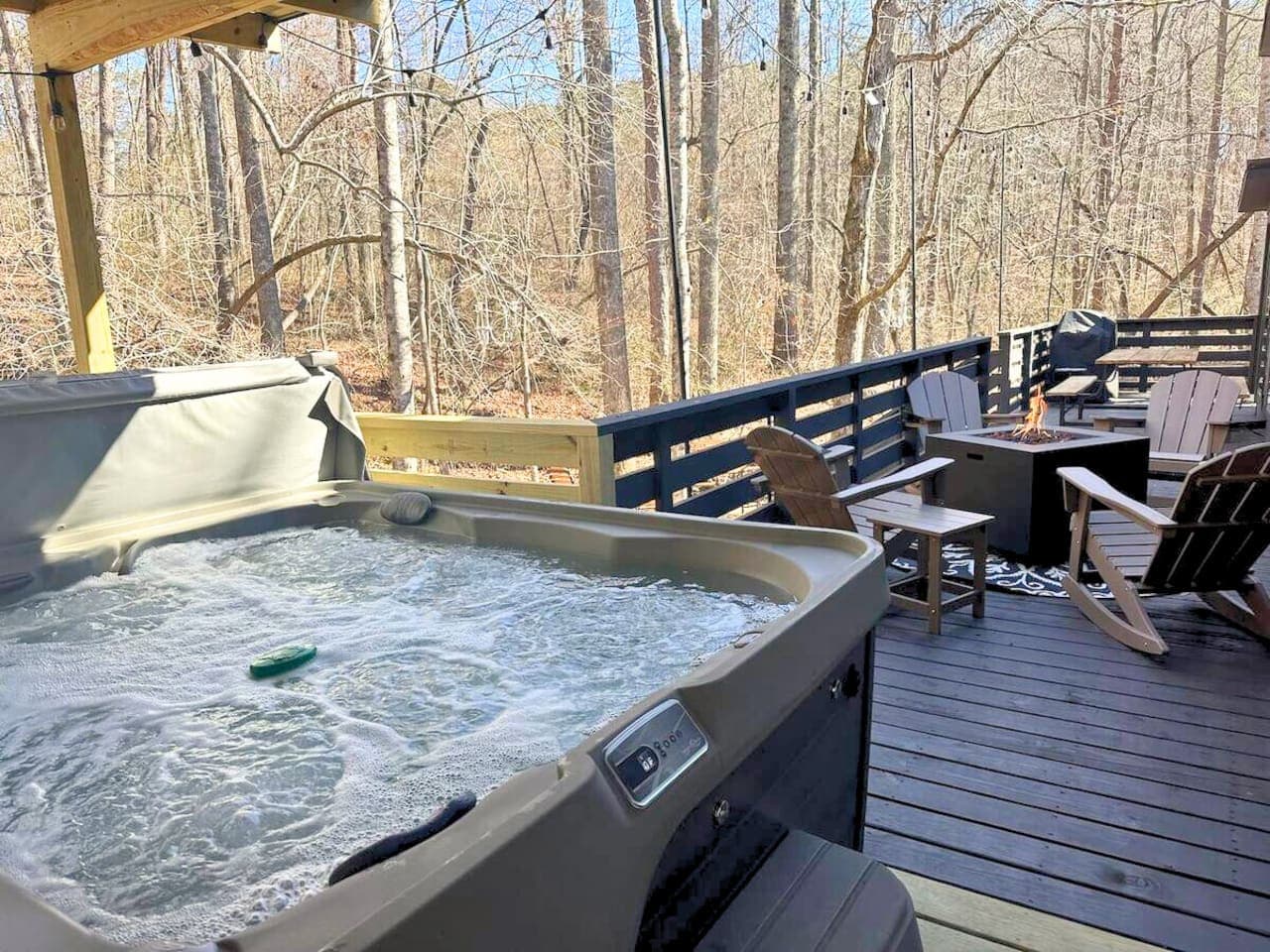 The hot tub and outdoor fire pit create the perfect setting to relax, unwind, and enjoy the soothing sights and sounds of the creek.