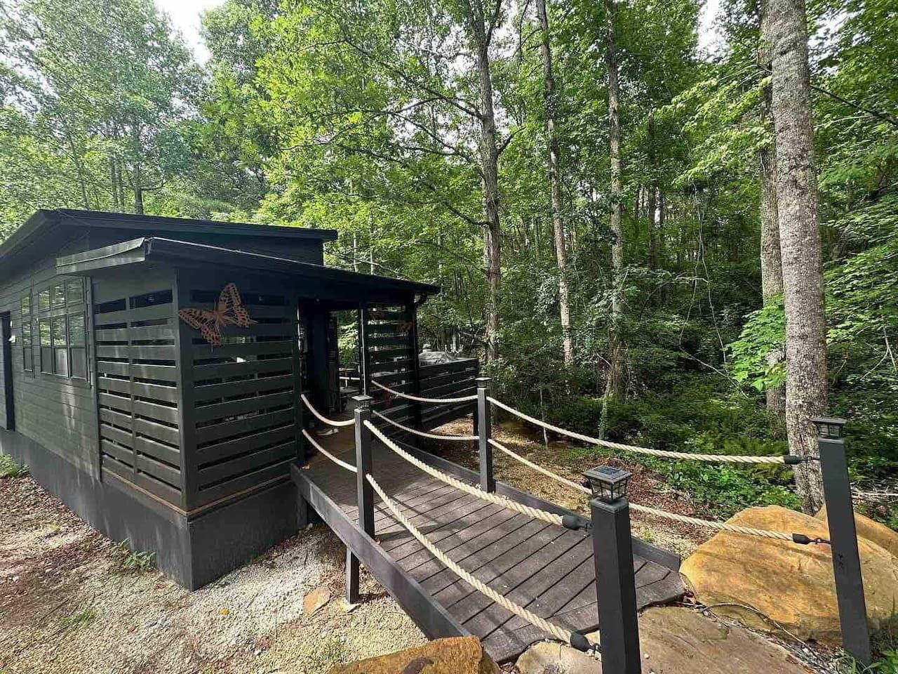 A charming wooden bridge leads to the home, adding a touch of whimsy and a storybook feel to your stay.