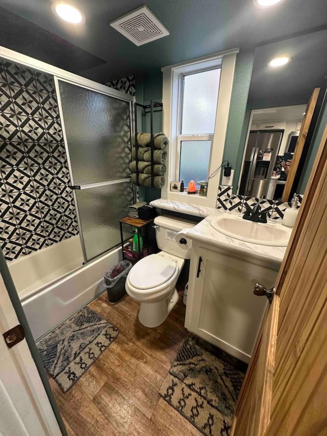 The bathroom features a full tub and shower combo with towels, toiletries, and essentials provided—everything you need to freshen up after a day of creekside adventures.