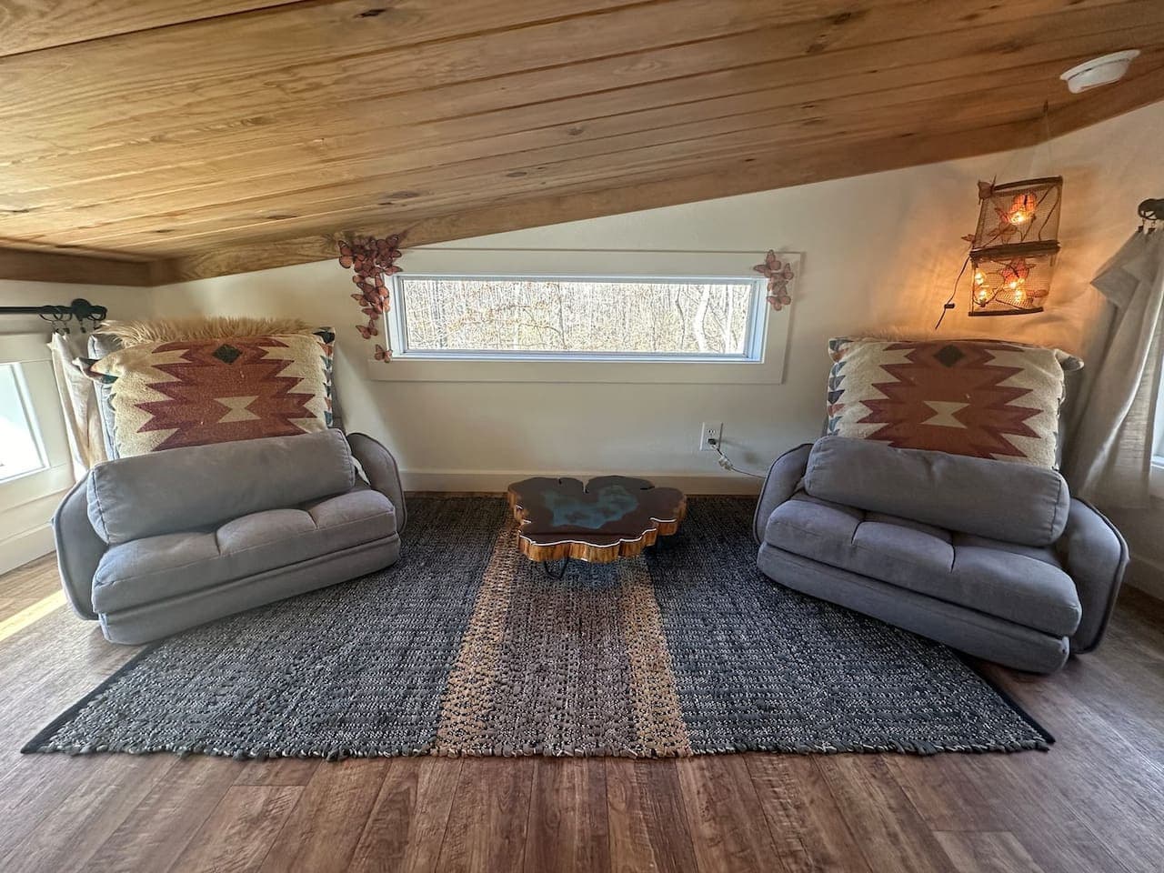 The loft sitting area features two floor chairs and a butterfly table—perfect for card games, snacks, or pretending it’s your secret clubhouse.