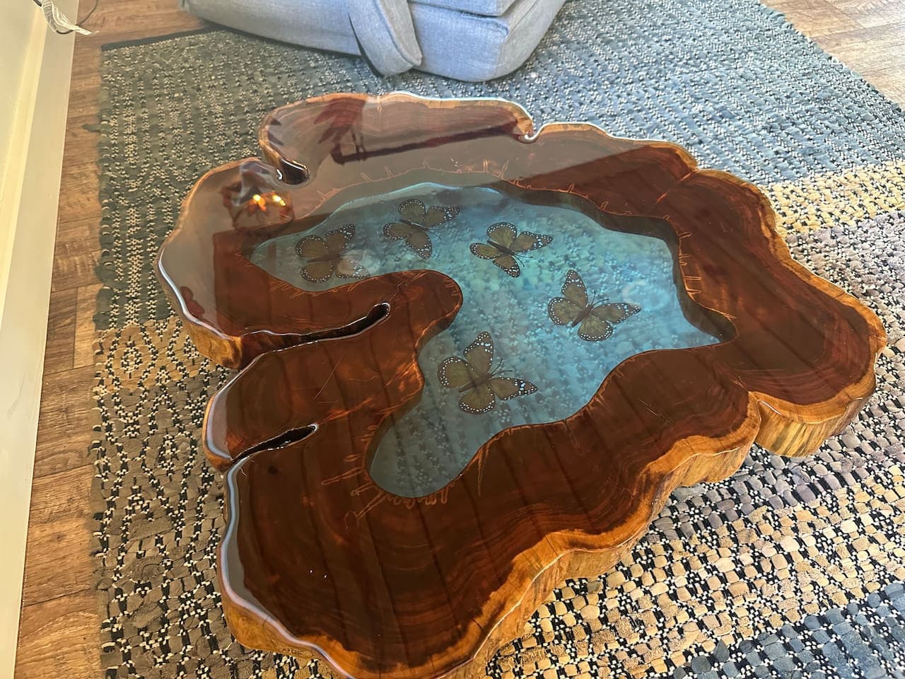 The butterfly table steals the spotlight—a gorgeous piece that’s equal parts furniture and art, perfect for fluttering conversations or morning coffee.