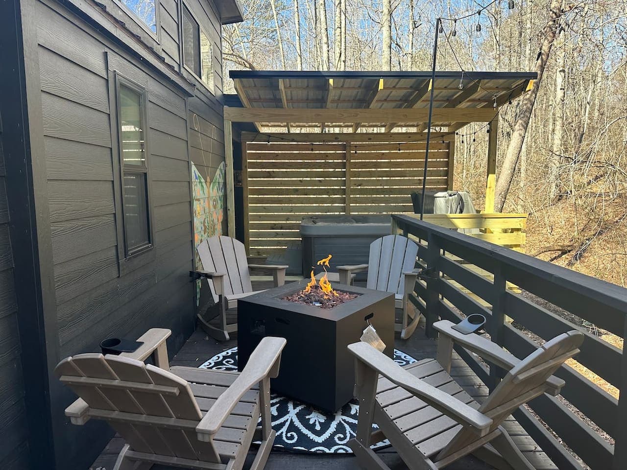 The outdoor fire pit provides a welcoming space to unwind, enjoy the warmth of the flames, and take in the peaceful sounds of the surrounding creek and forest.