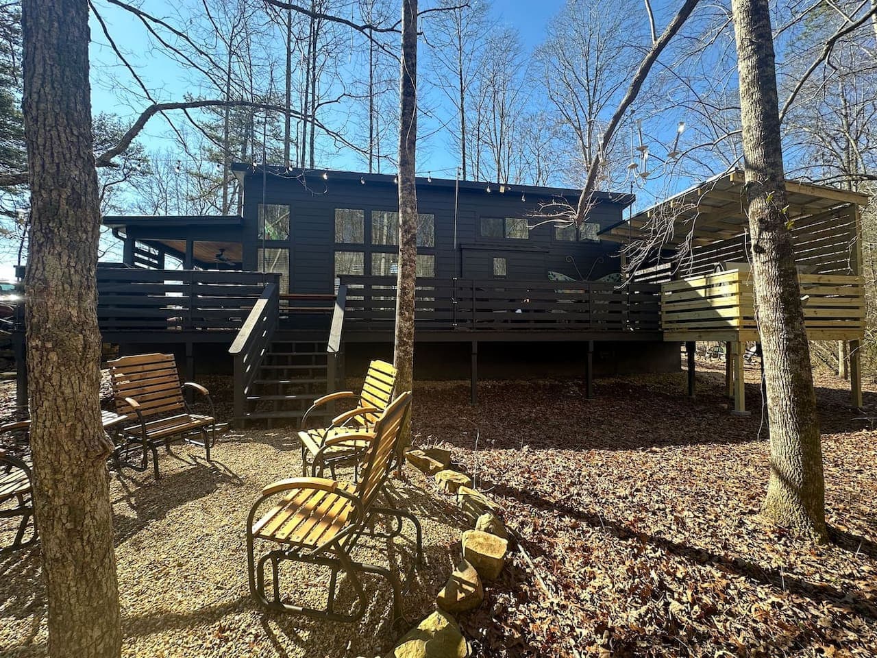 The exterior of the home blends rustic charm with natural beauty, surrounded by trees, creek views, and the peaceful atmosphere of Blueberry Falls Farm.