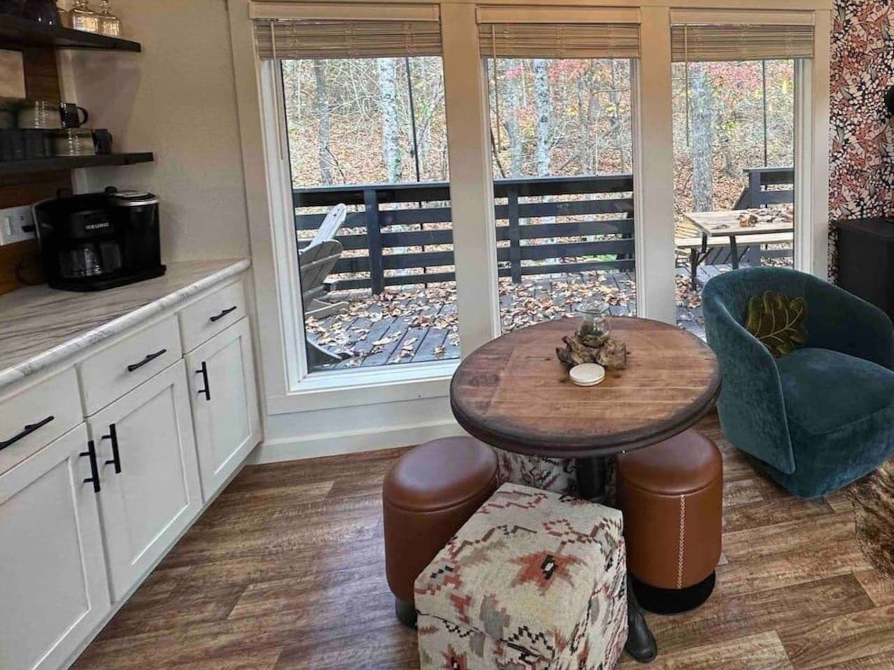 The dining area features a round table with stools that seat four and doubles as a laptop-friendly workspace.