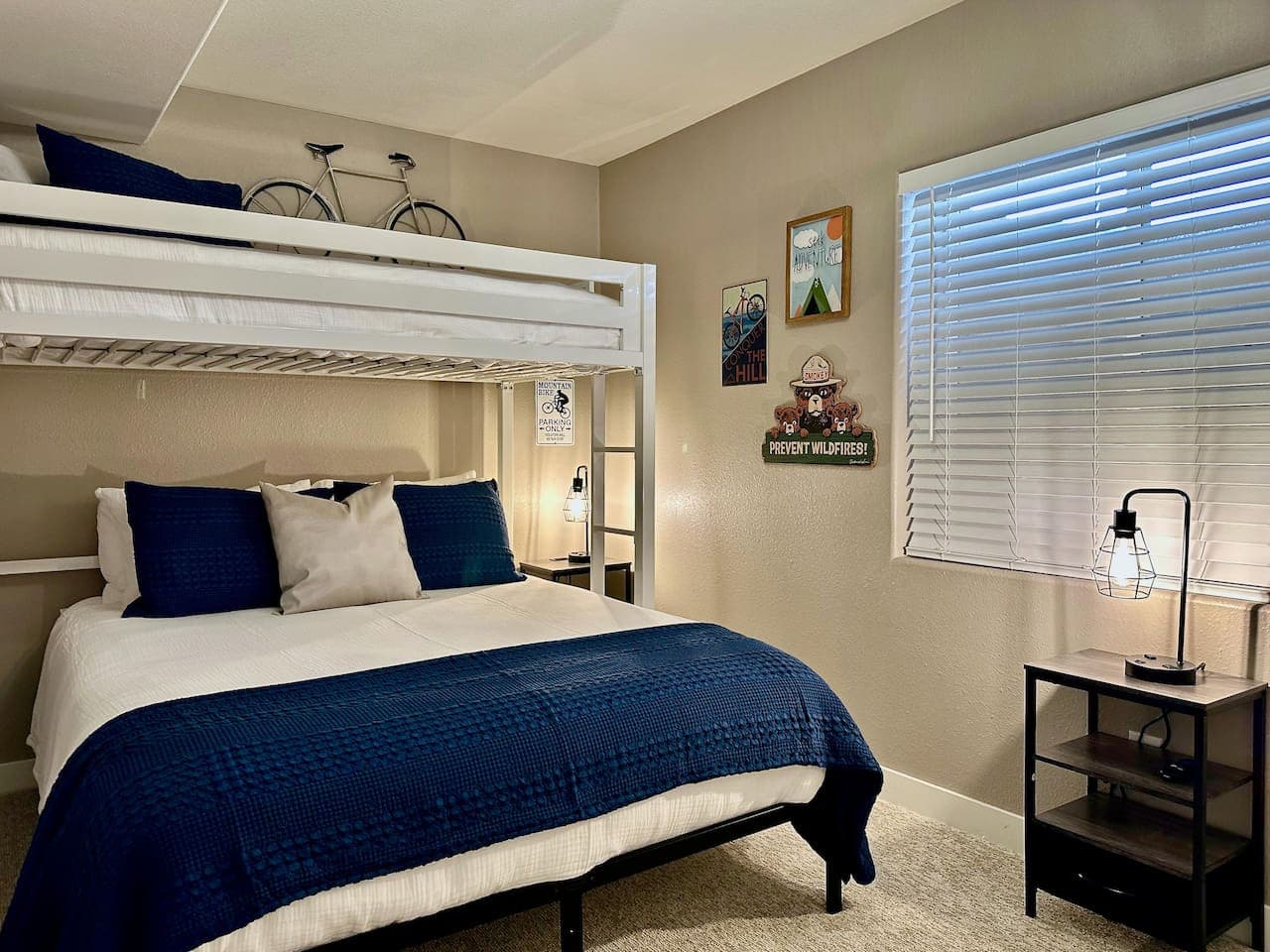 This unique queen bedroom with a twin loft bed above offers a versatile sleeping solution, ideal for families or friends.