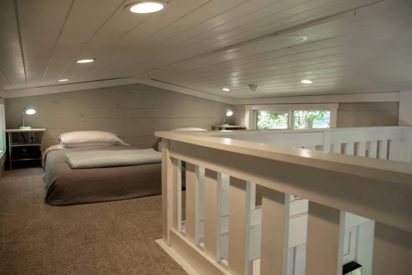A simple loft with two twin beds designed for a peaceful night’s sleep.