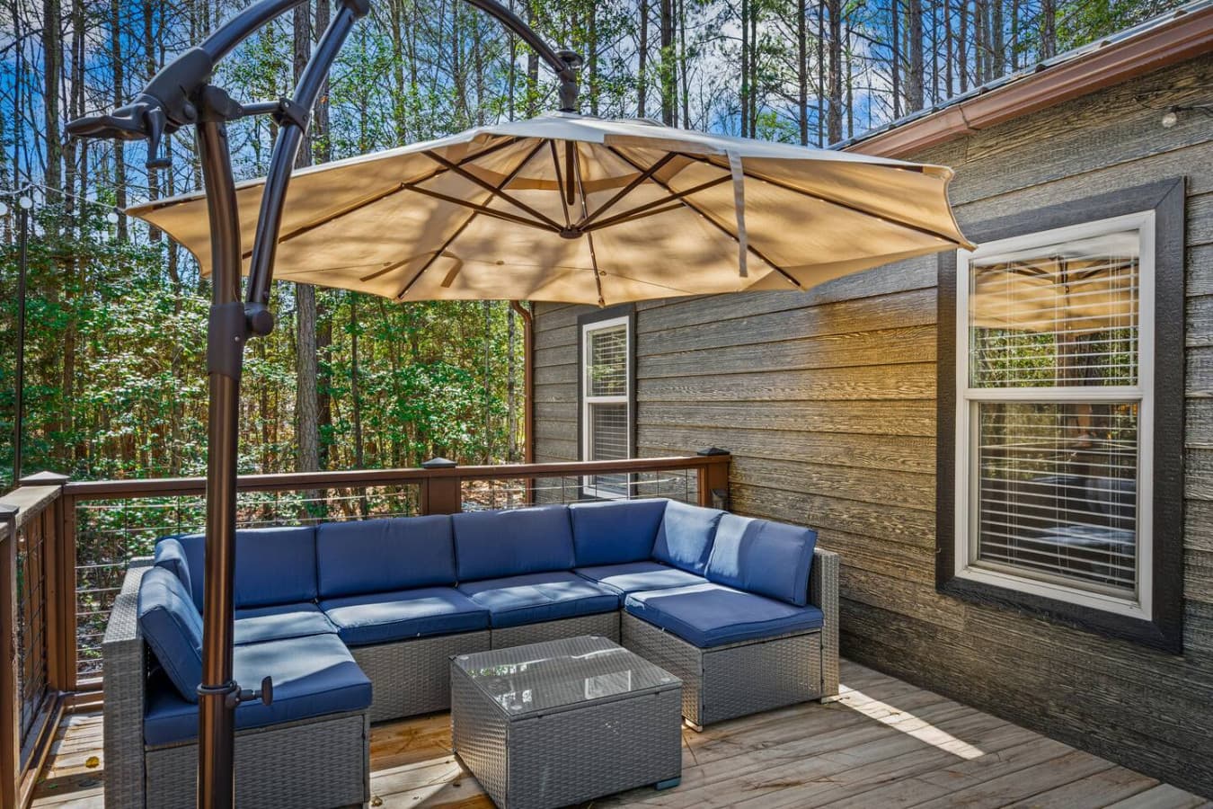A welcoming patio space with cozy seating and a grill, ideal for everything from morning coffee to evening cookouts.