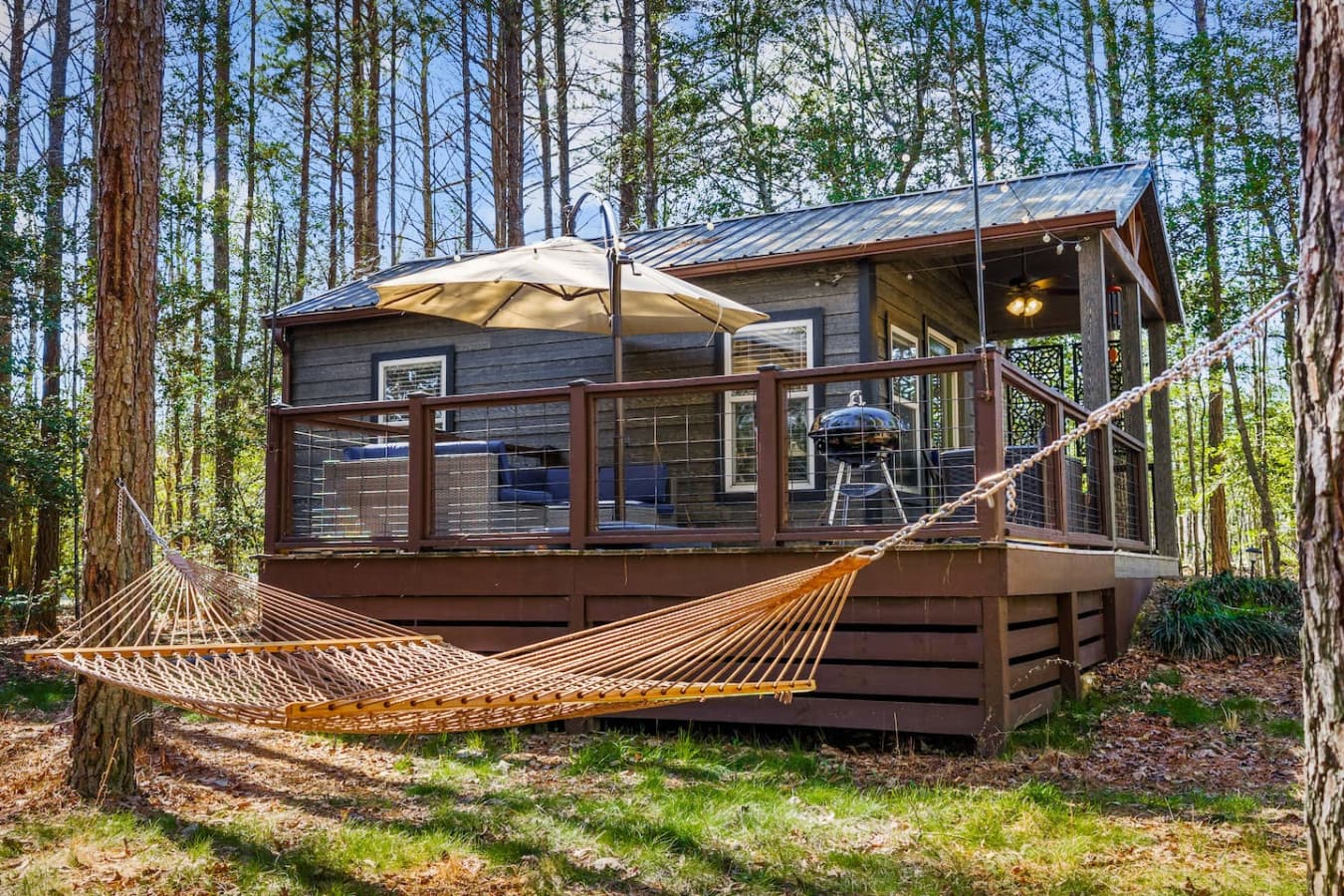 Relax in the hammock near the fire pit—perfect for lazy afternoons and cozy evenings in the front yard.