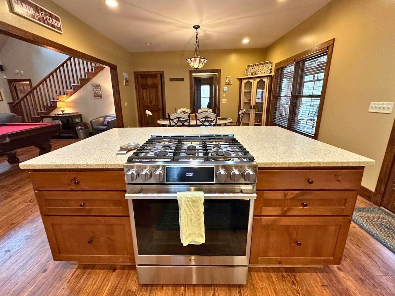 The kitchen features a gas stove and oven built into the kitchen island.