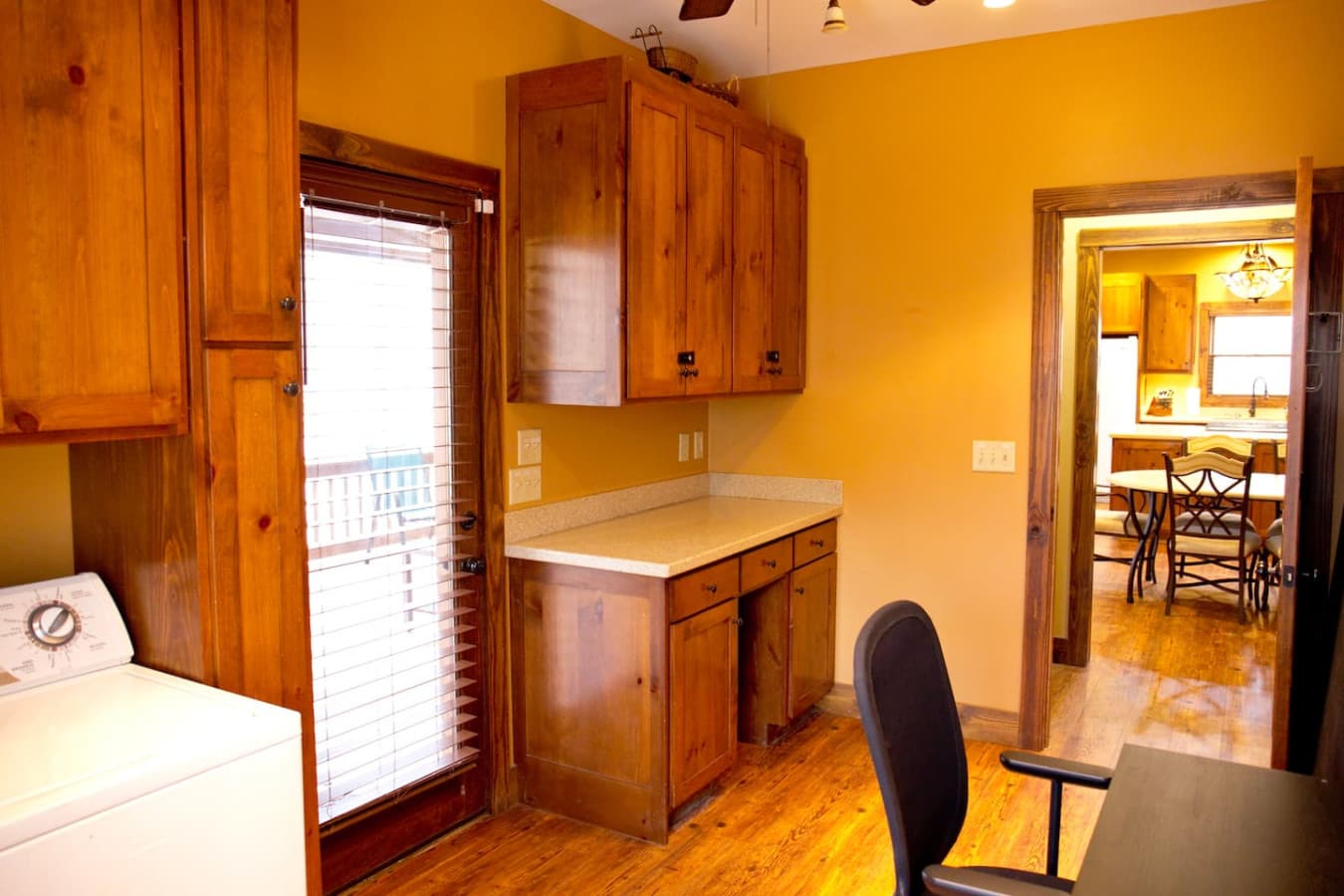 The laundry area doubles as a work space, with a door that leads directly to the screened-in porch—perfect for stepping out and enjoying the fresh air during breaks.