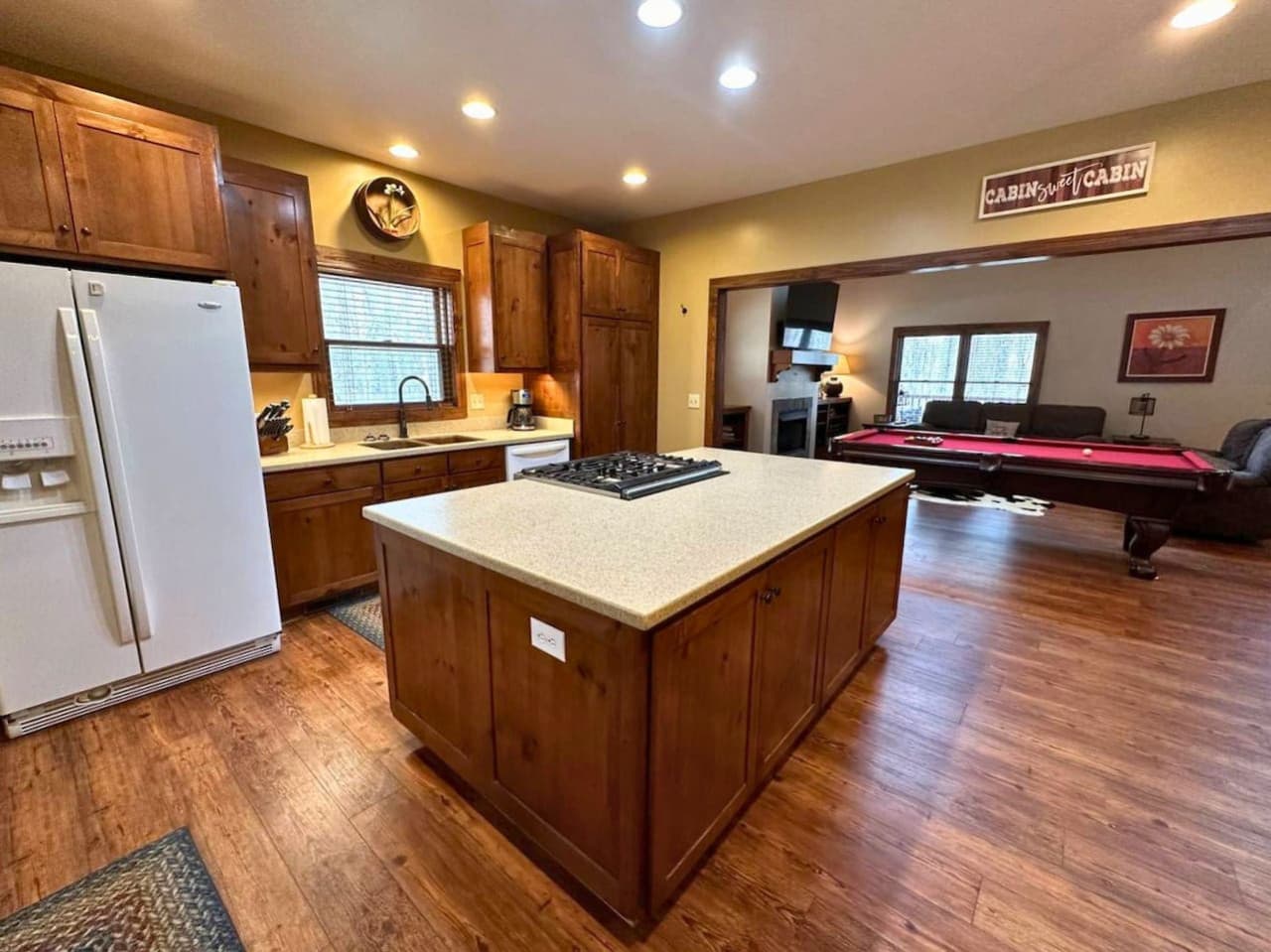 The kitchen features a gas stove and oven built into the kitchen island.