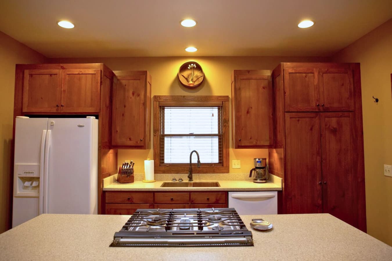 The kitchen features a gas stove and oven built into the kitchen island.