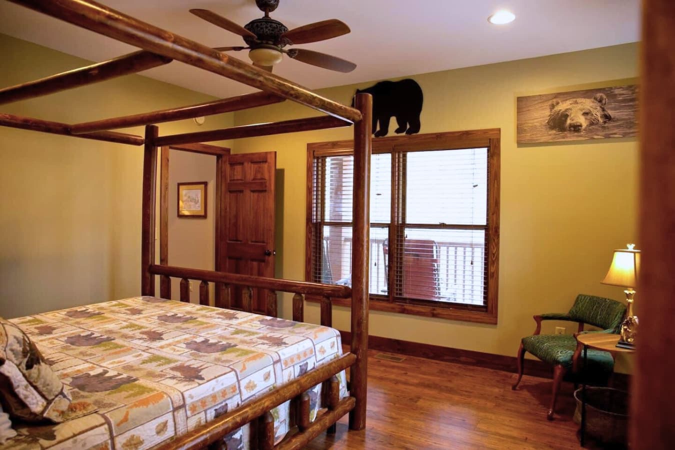 The master bedroom on the main floor features a king bed with a king sheet set, quilt, and two pillows, along with an attached bathroom.