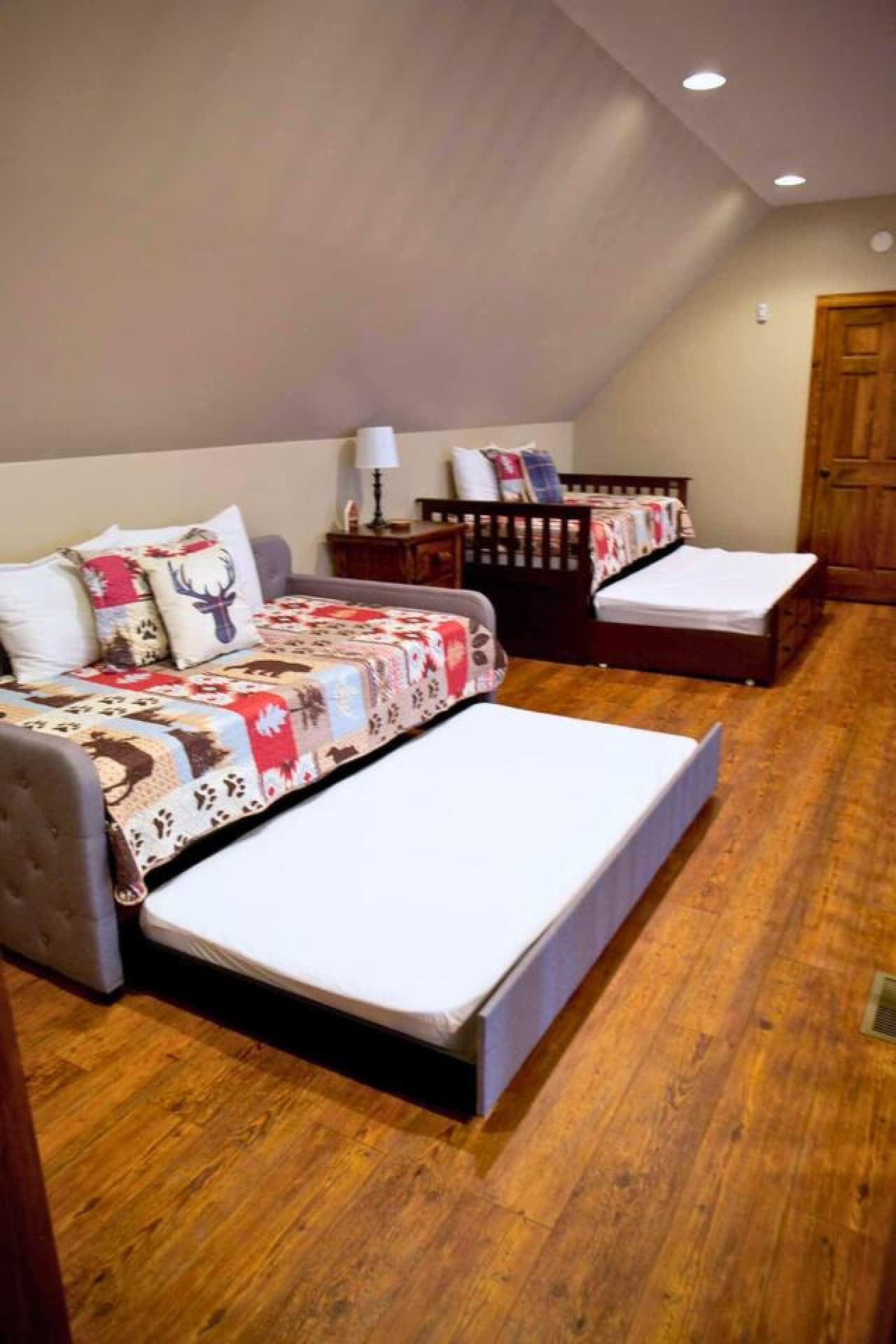 This loft features two trundle beds, each with a pull-out option, providing a total of four twin-sized beds for additional sleeping space.